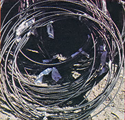 Recycled cable rolled into loose coils.
